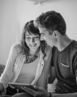 Couple qui regarde en souriant son ordinateur